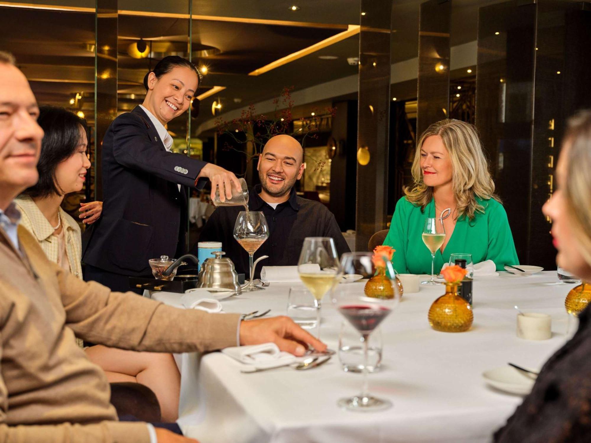 Sofitel Legend The Grand Amsterdam Hotel Ngoại thất bức ảnh A wine steward serves wine at a restaurant